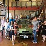 HomeAway employees posing in front of Wagon Queen Family Truckster from National Lampoon's Vacation