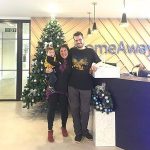 HomeAway employees standing in front of Christmas Tree