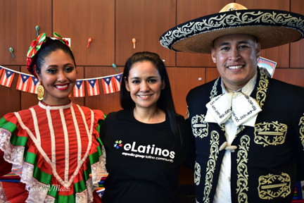 three people in festive gear smiling at camera