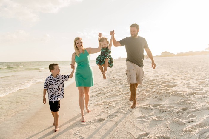 Family of four walking on the beach