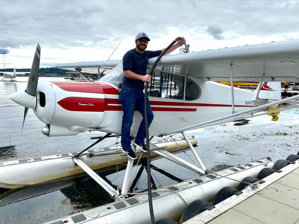 Man wearing hat standing on a hydroplane